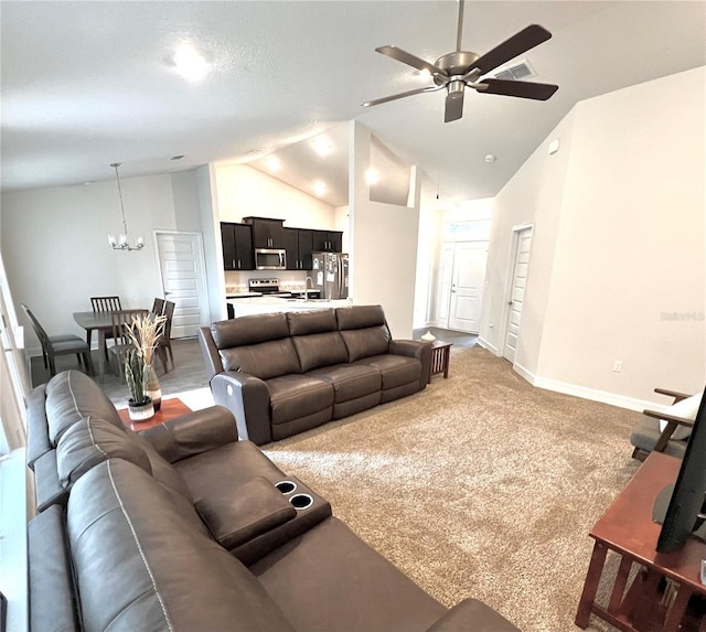 living room featuring ceiling fan with notable chandelier, high vaulted ceiling, and carpet floors