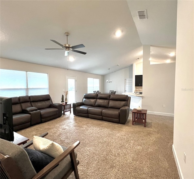 living room featuring lofted ceiling, sink, ceiling fan, and carpet