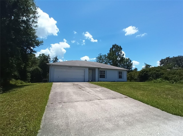 ranch-style home with a garage and a front yard