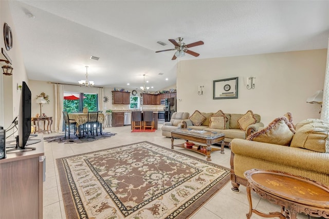 tiled living room with ceiling fan with notable chandelier