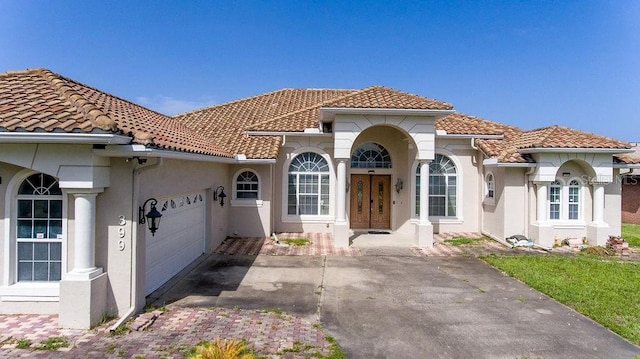 mediterranean / spanish home with a garage