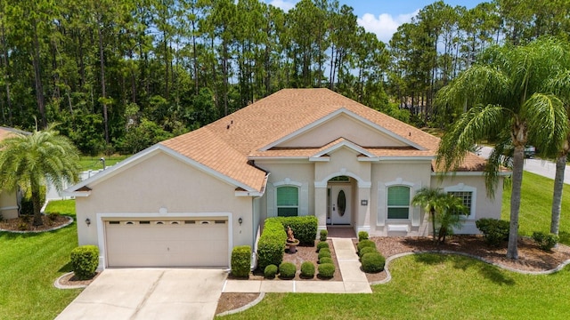 mediterranean / spanish-style home featuring a garage and a front lawn