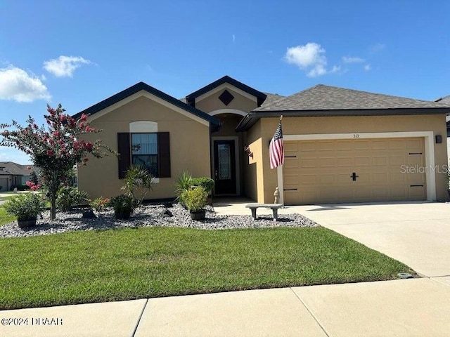 view of front of house with a garage and a front lawn