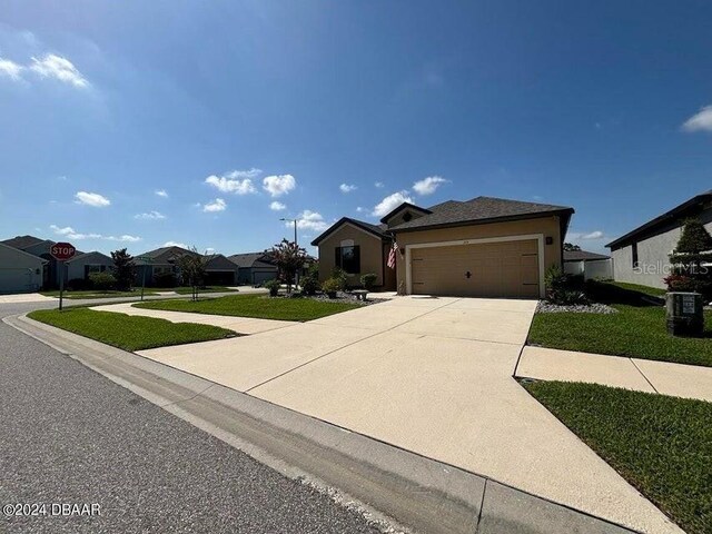 view of front of house with a garage and a front yard