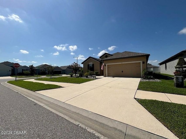 view of front facade featuring a garage, a front yard, and central air condition unit