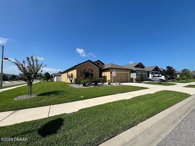 view of front of house with a garage and a front yard