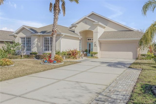 view of front of property featuring a garage and a front lawn