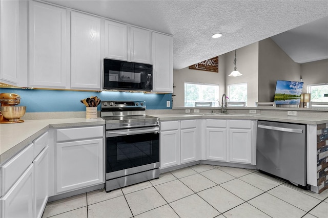 kitchen featuring appliances with stainless steel finishes, a textured ceiling, light tile patterned floors, and white cabinetry