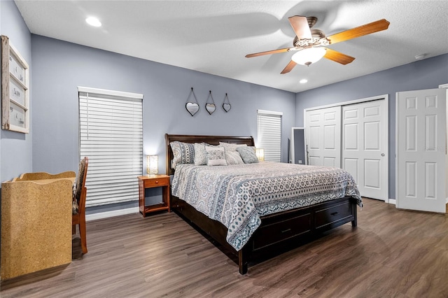 bedroom featuring dark hardwood / wood-style floors, a textured ceiling, a closet, and ceiling fan