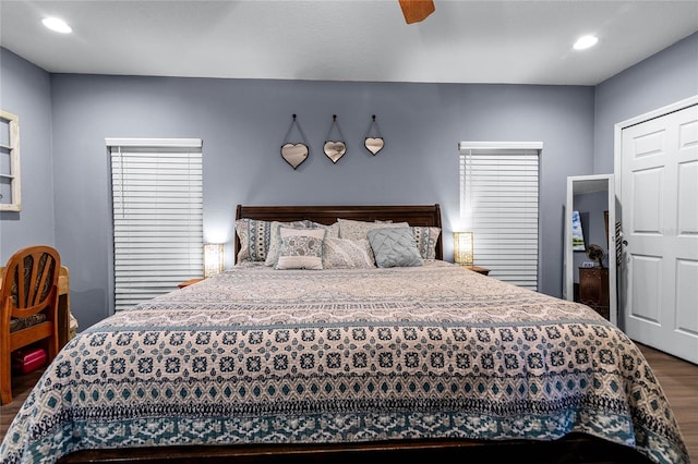 bedroom featuring ceiling fan, wood-type flooring, and a closet