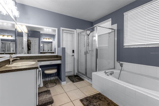 bathroom featuring vanity, shower with separate bathtub, tile patterned floors, and a textured ceiling