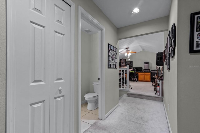 hall featuring light colored carpet and vaulted ceiling