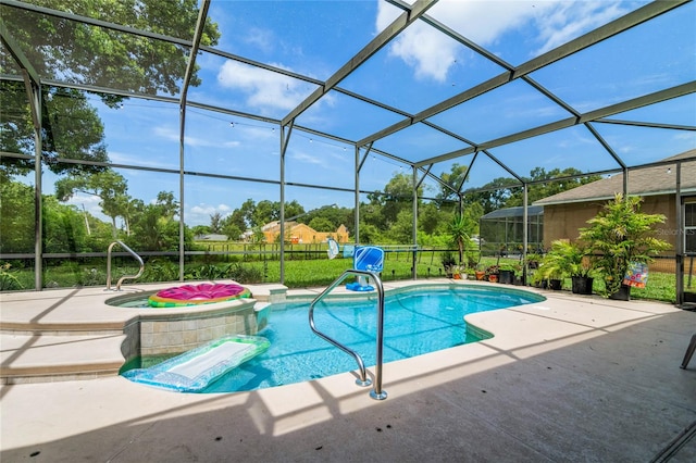 view of pool featuring glass enclosure, a patio area, and a jacuzzi