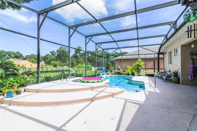 view of swimming pool with a patio and a lanai