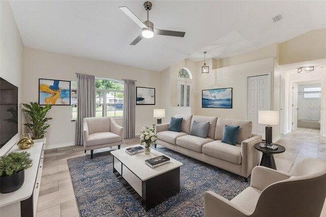 living room with lofted ceiling and ceiling fan