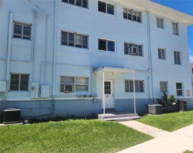 view of building exterior featuring cooling unit and central AC unit