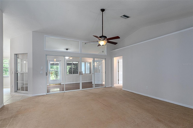 unfurnished living room with ceiling fan, lofted ceiling, and light colored carpet