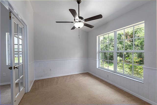 unfurnished room with ceiling fan and carpet flooring