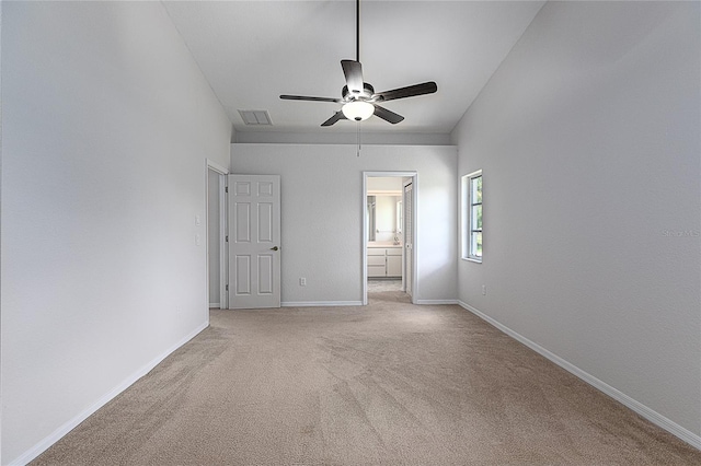 carpeted empty room featuring ceiling fan