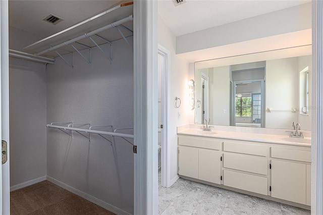 bathroom featuring double vanity and tile patterned floors