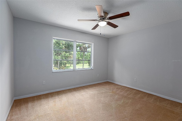 carpeted empty room featuring a textured ceiling and ceiling fan