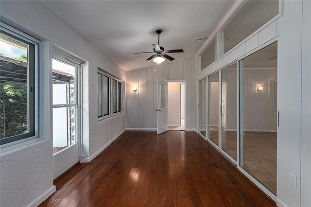 interior space with dark colored carpet and vaulted ceiling