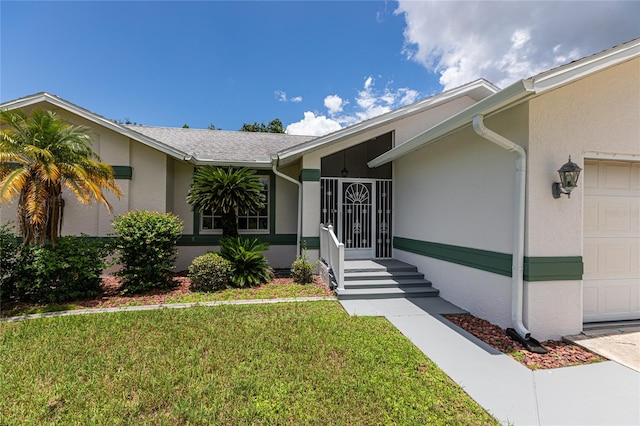 view of front of home with a garage and a front yard