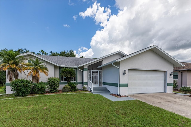 single story home featuring a garage and a front lawn