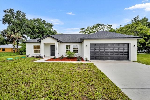 view of front of house featuring a garage and a front yard