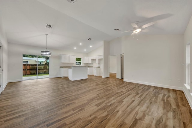 unfurnished living room featuring light hardwood / wood-style flooring, high vaulted ceiling, and ceiling fan