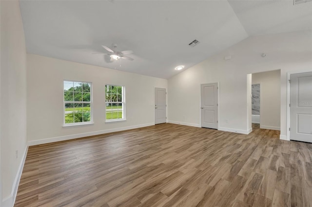 interior space with ceiling fan, vaulted ceiling, and light wood-type flooring