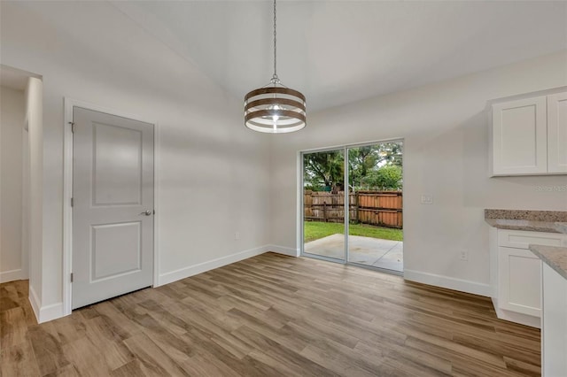 unfurnished dining area with light hardwood / wood-style floors