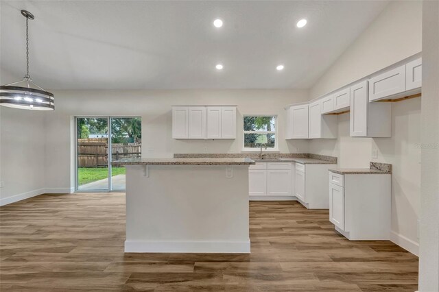 kitchen featuring white cabinetry, a healthy amount of sunlight, and light wood-type flooring