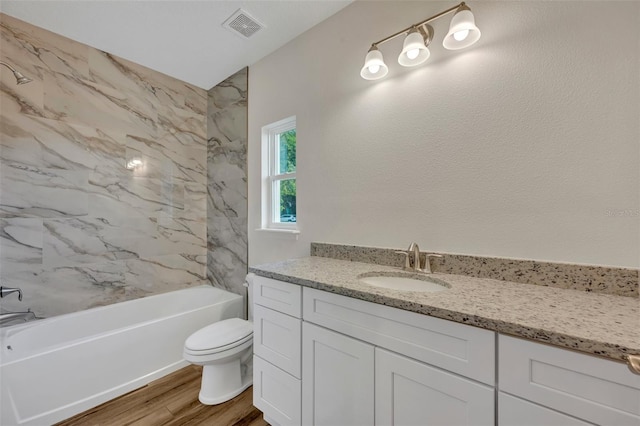 bathroom with vanity, toilet, and hardwood / wood-style floors