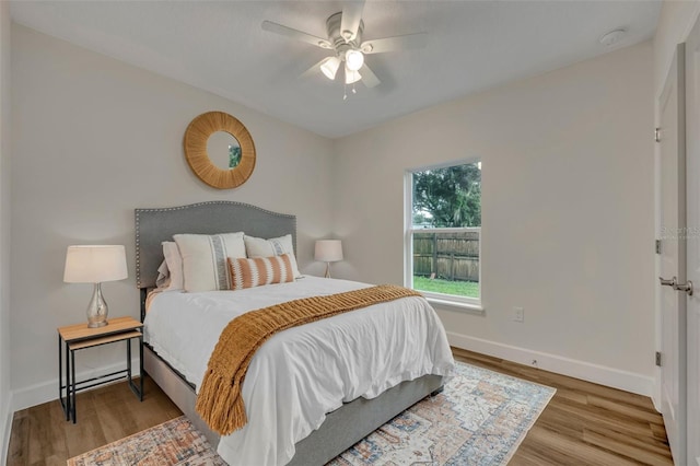 bedroom with ceiling fan and light wood-type flooring