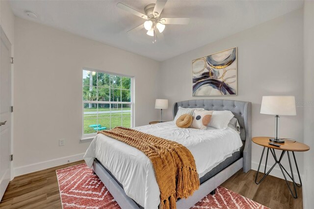 bedroom with light hardwood / wood-style flooring and ceiling fan