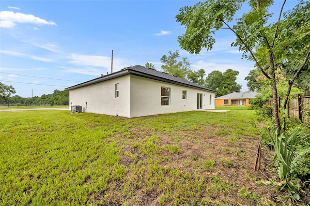 exterior space with a yard and central AC unit