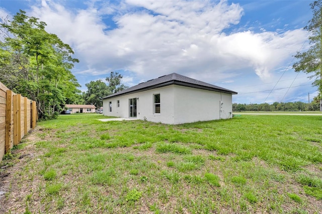 210 E Baxter St, De Leon Springs, FL 32130 - rear view of property with stucco siding