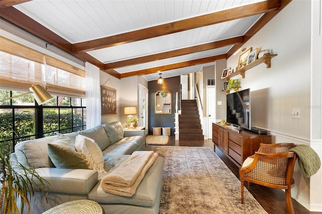 living room with dark hardwood / wood-style flooring and vaulted ceiling with beams