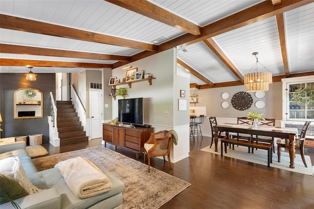 living room featuring dark hardwood / wood-style floors, a notable chandelier, and vaulted ceiling with beams