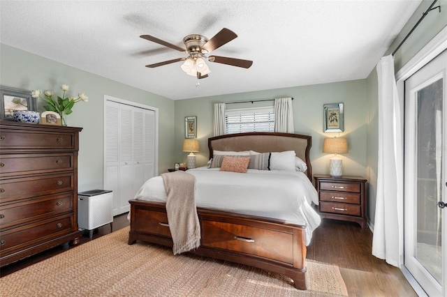 bedroom featuring a textured ceiling, access to outside, ceiling fan, hardwood / wood-style flooring, and a closet