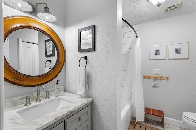 full bathroom with vanity, toilet, shower / bathtub combination with curtain, and a textured ceiling