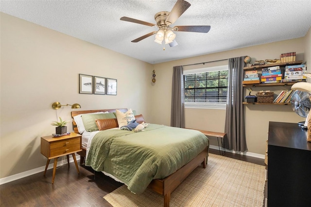 bedroom featuring a textured ceiling, ceiling fan, and hardwood / wood-style floors