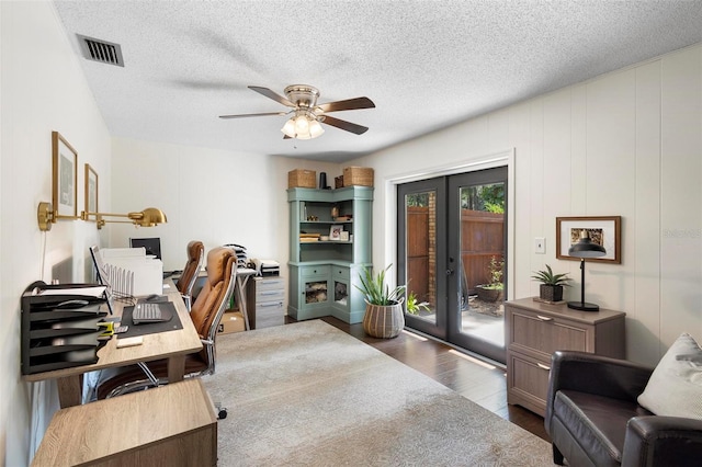 office area with ceiling fan, dark hardwood / wood-style floors, french doors, and a textured ceiling