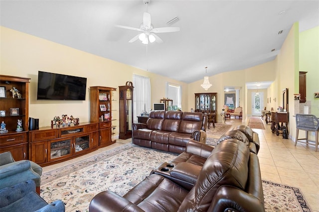 living room with lofted ceiling, visible vents, ceiling fan, and light tile patterned floors