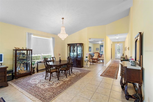 dining space featuring lofted ceiling, baseboards, a notable chandelier, and light tile patterned flooring