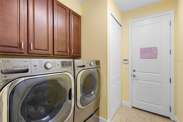 washroom with cabinets, light tile patterned floors, and independent washer and dryer