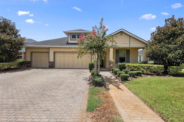 view of front of property featuring a garage and decorative driveway