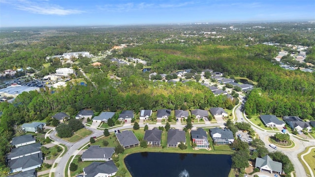 bird's eye view featuring a water view, a wooded view, and a residential view