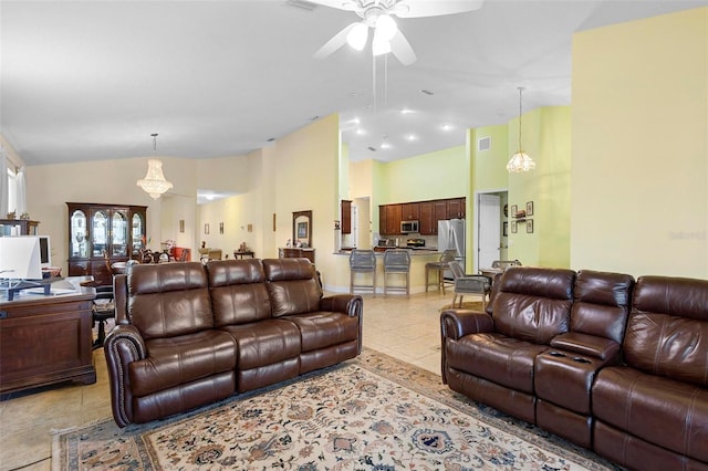 living room featuring high vaulted ceiling, light tile patterned flooring, and a ceiling fan